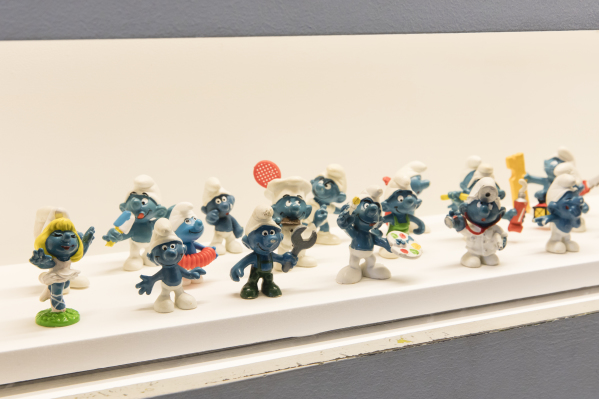 Photograph of Seventeen Smurf figurines on display